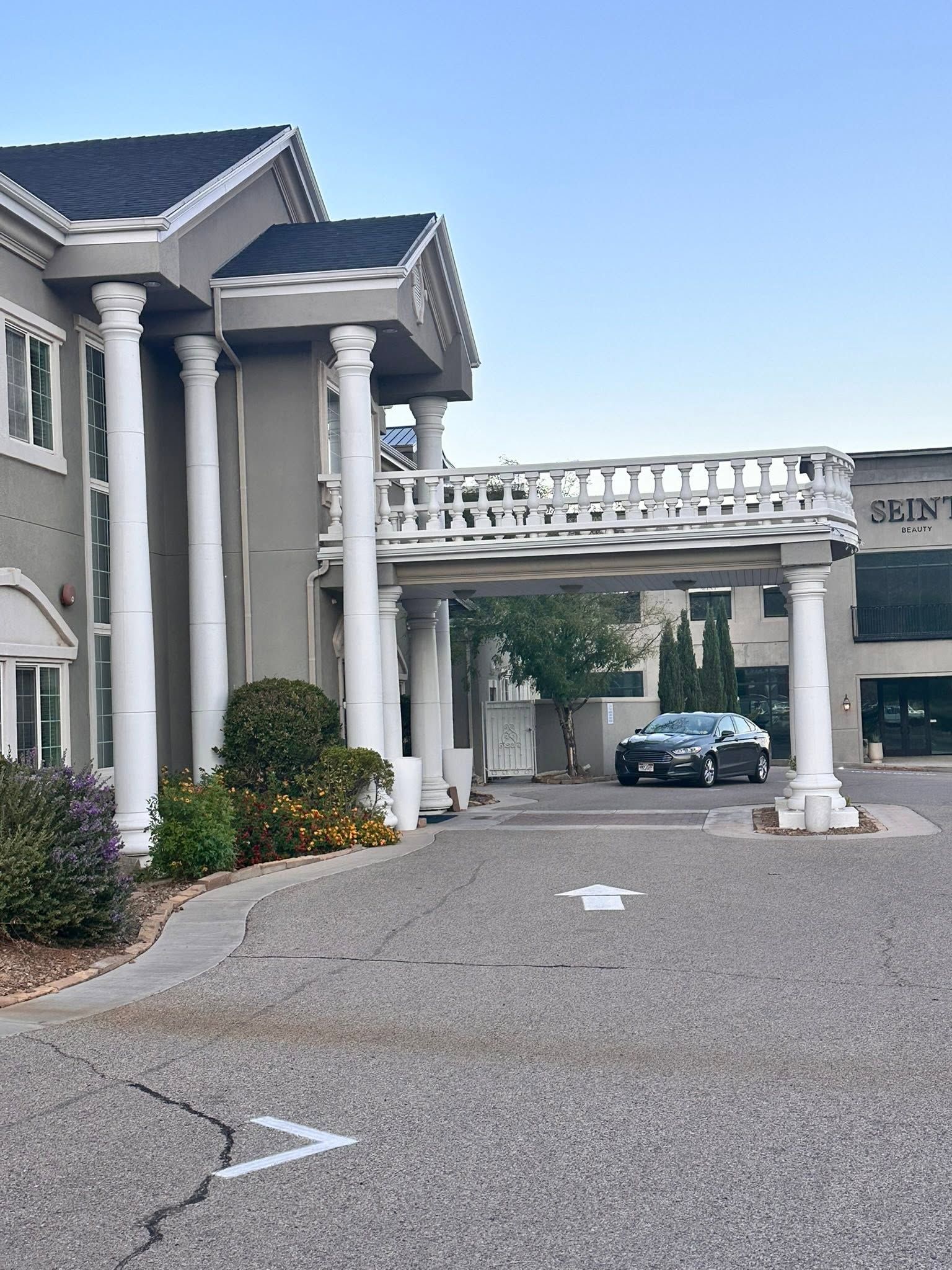 A commercial entry with tall foam columns and a foam balustrade over the drive