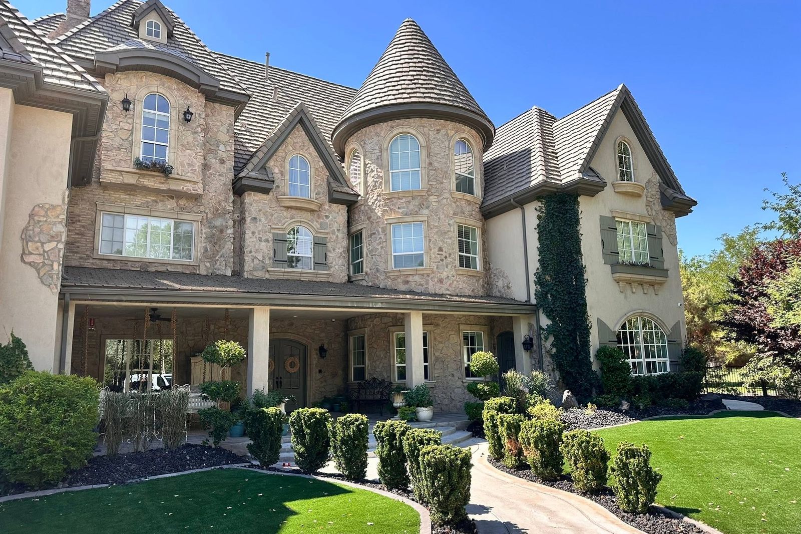 A custom home finished with foam window surrounds, banding, and corbels over stone